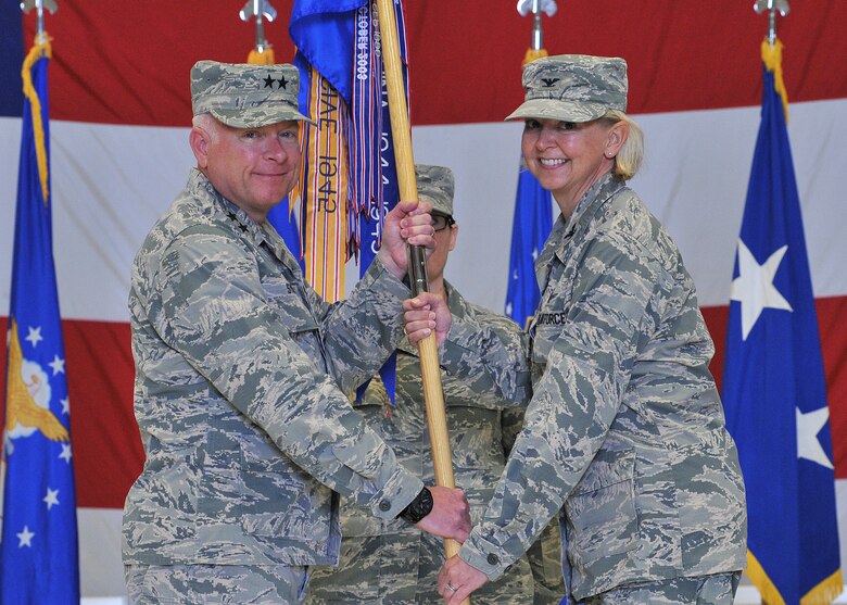 U.S. Air Force Col. Jennifer Reeves, right, accepts command of the 341st Missile Wing from Maj. Gen. Fred Stoss, 20th Air Force commander, as Chief Master Sgt. Amber Mitchell, 341st MW guidon bearer, looks on during a change of command ceremony at Malmstrom Air Force Base, Mont., June 19, 2018. Reeves’ previous assignment was 381st Training Group commander, Air Education and Training Command, at Vandenberg AFB, Calif. The 341st Missile Wing, headquartered at Malmstrom AFB, is one of three U.S. Air Force bases that maintains and operates the Minuteman III intercontinental ballistic missile. (U.S. Air Force photo by John Turner)