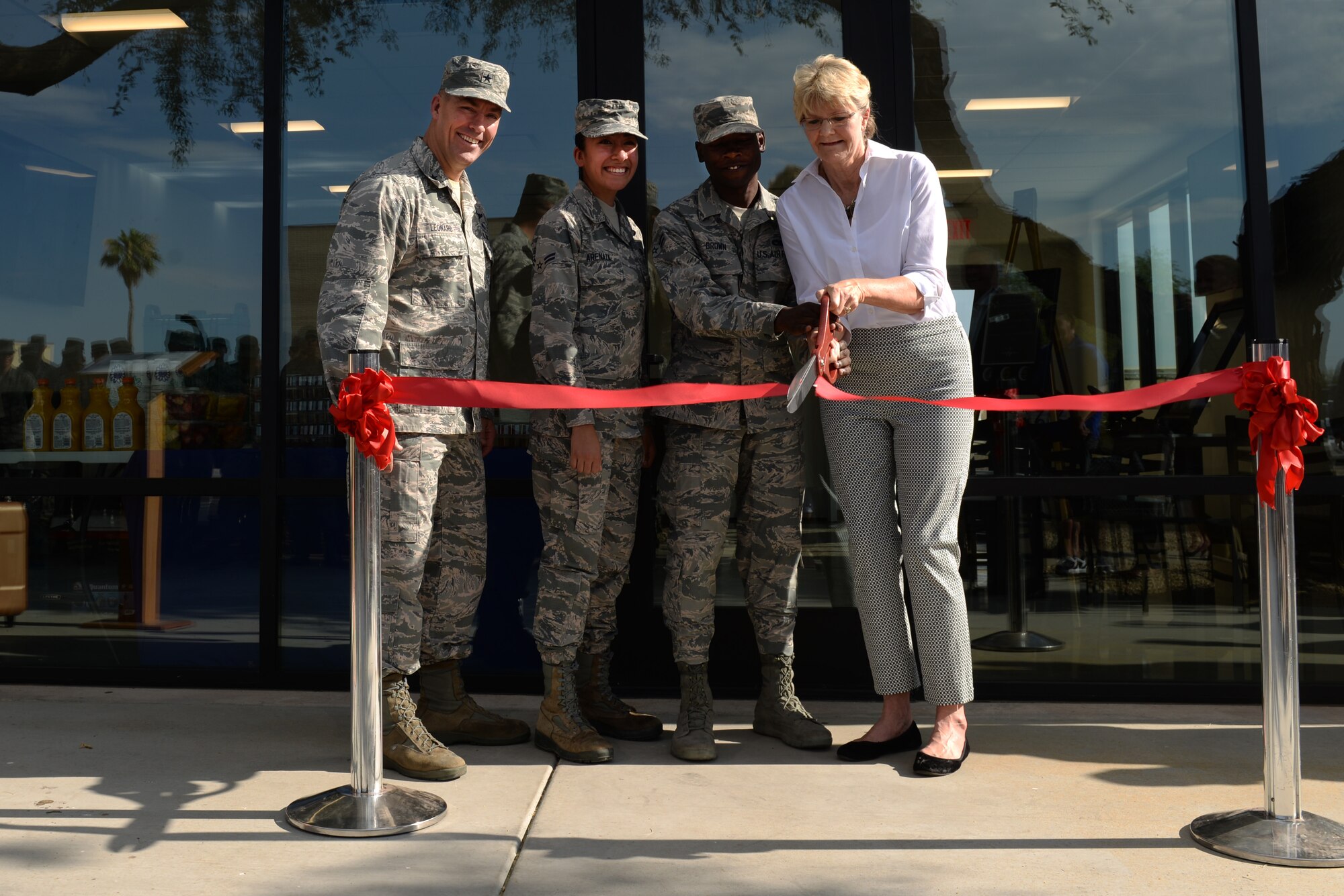 Airmen and sponsors involved in developing the flightline kitchen expansion cut the ribbon to officially open it at Luke Air Force Base, Ariz., June 14, 2018. The expansion was primarily funded by donations from community partners. (U.S. Air Force photo by Senior Airman Ridge Shan)