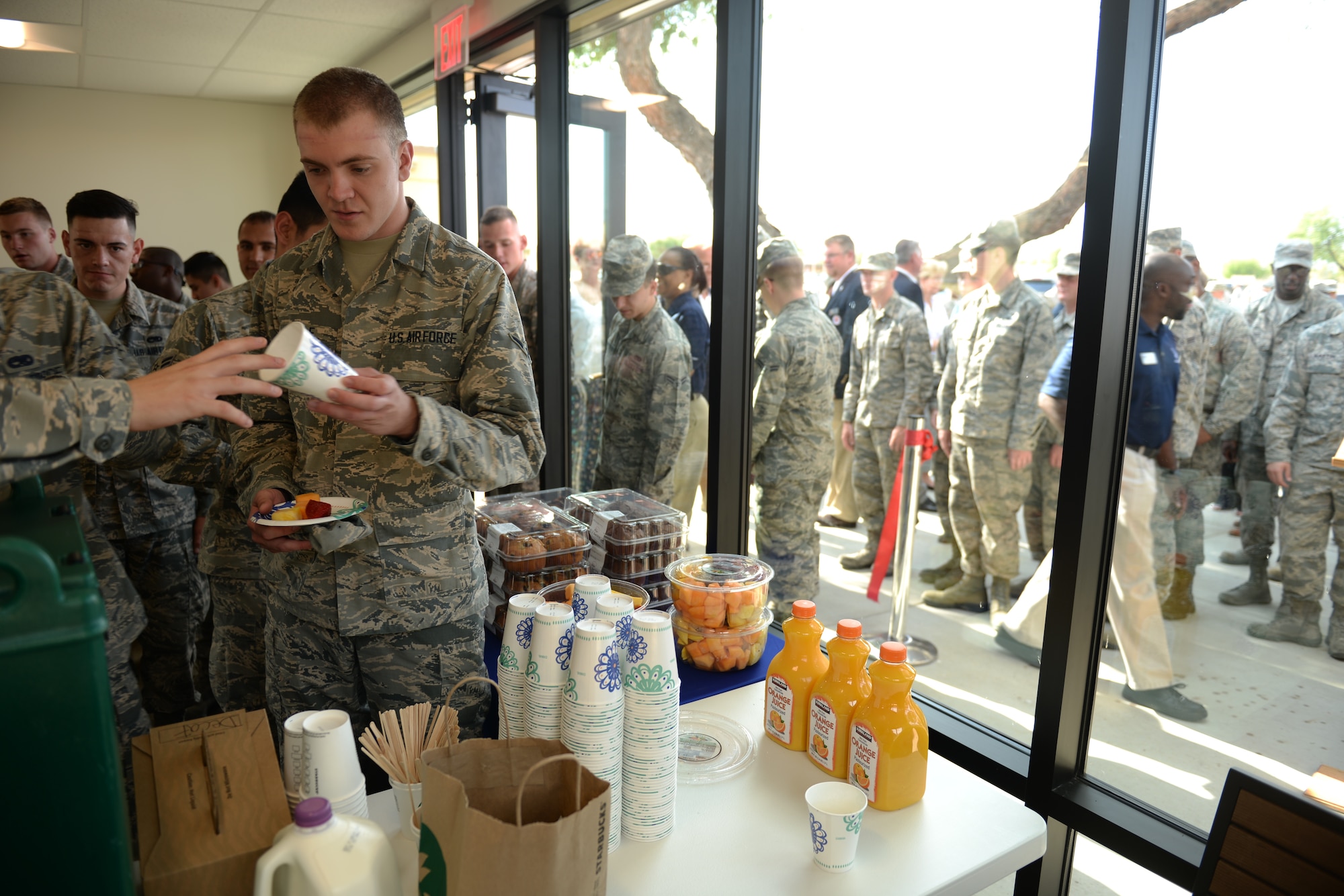 Airmen line up to get breakfast inside the flightline kitchen expansion shortly following its ribbon-cutting at Luke Air Force Base, Ariz., June 14, 2018. Airmen who work on the flightline can enjoy meals in the air conditioned expansion during long work shifts. (U.S. Air Force photo by Senior Airman Ridge Shan)