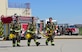 Rapid City Fire Department cadets walk across the fire training area during a training exercise at Ellsworth Air Force Base, S.D., June 21, 2018. During the exercise, cadets and firefighters put out 15 controlled fires burning at 700 degrees Fahrenheit. (U.S. Air Force photo by Senior Airman Randahl J. Jenson)