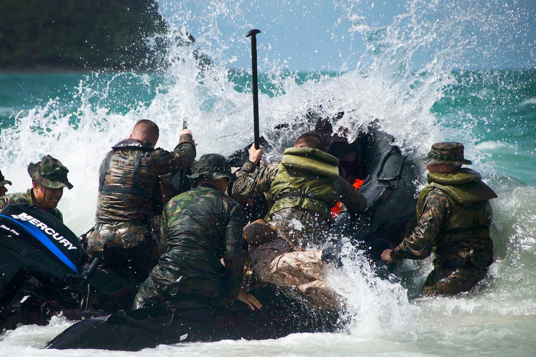 U.S and Royal Thai marines crash the waves while conducting combat rubber raiding boat operations.