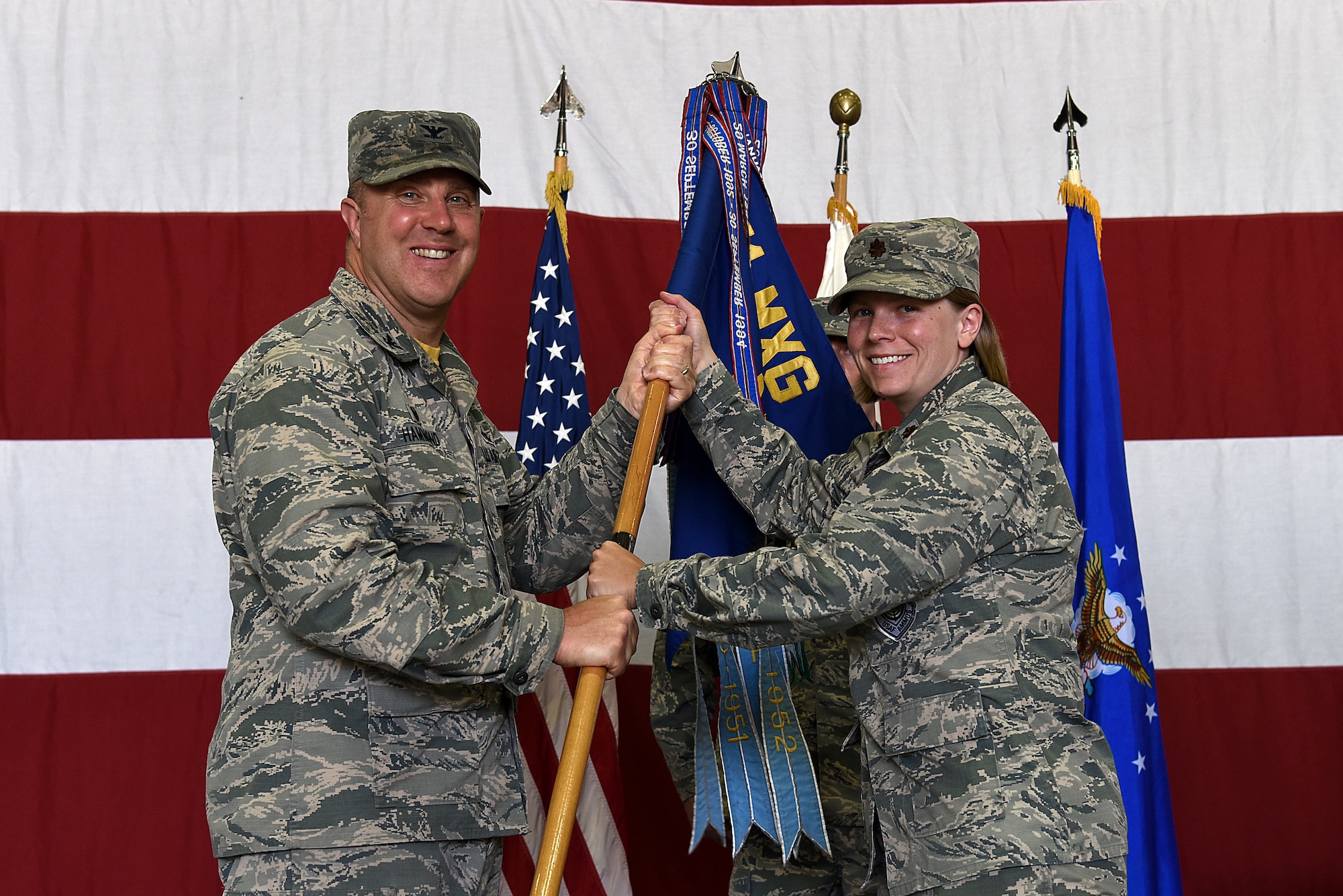 U.S. Air Force Maj. Kristen Torma receives the 51st Maintenance Squadron (MXS) guidon from Col. Michael Hammond, 51st Maintenance Group commander, during a change of command ceremony at Osan Air Base, Republic of Korea, June 21, 2018. Prior to taking leadership of 51st MXS, Torma served as commander of the 20th Aircraft Maintenance Squadron at Shaw Air Force Base, South Carolina. (U.S. Air Force photo by Senior Airman Kelsey Tucker)