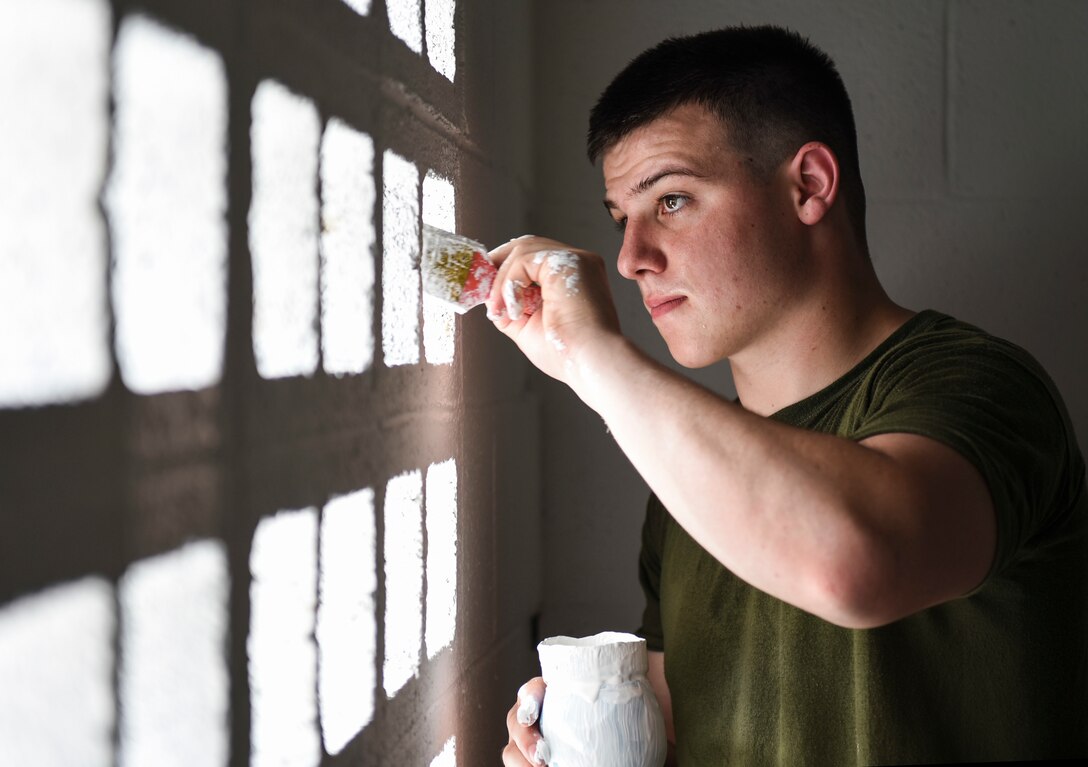 U.S. Marine Corps Reserve Lance Cpl. Dakota Hospelhorn, 346th Air Expeditionary Group combat engineer who is deployed from the 6th Engineer Support Battalion, Peoria, Illinois, paints a structure May 29, 2018, in Meteti, Panama.