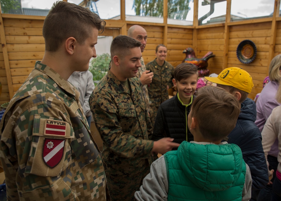U.S. Marines with 2nd Civil Affairs Group, Latvian Zemessardze (national guardsmen) and children from Priedites Orphanage intermingle at a local pottery art house in Daugavpils, Latvia, June 5, 2018, during a community event as part of Exercise Saber Strike 18. The Marines and Latvian Zemessardze, with the help of a nonprofit charity organization Spirit of America, visited the children of the Priedites Orphanage and treated them to a day full of activities including a trip to a local pottery art house and an outdoor playground obstacle course. Spirit of America is a non-profit organization that works alongside forward-deployed troops and diplomats serving overseas to identify critical needs and provide private-sector resources and know-how in support of their missions to increase their safety and success.(U.S. Marine Corps photo by Sgt. Adwin Esters/Released)