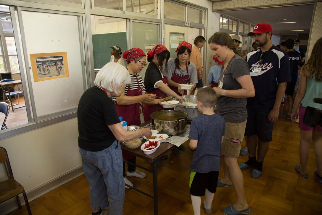 Station residents take to the fields, plant rice