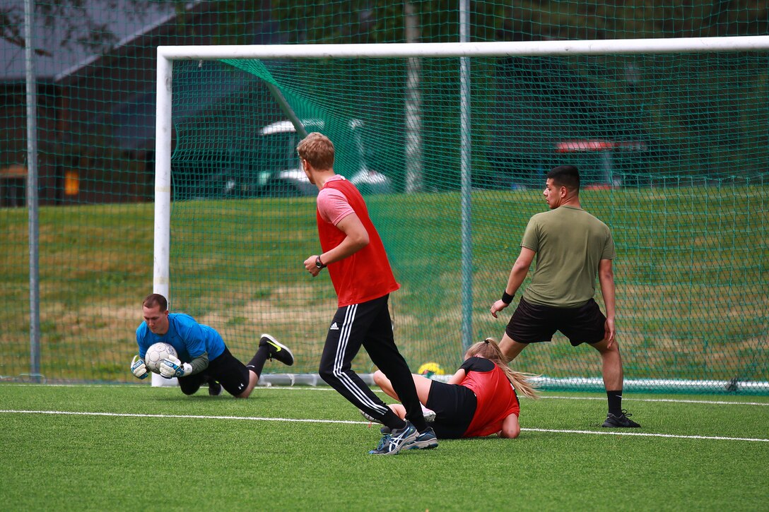 British Royal Marines and U.S. Marines with Marine Rotational Force-Europe 18.1 competed in a soccer game against Norwegian Soldiers with Home Guard 12 at Stordal, Norway, June 15, 2018. The Marines scored three goals in the second half to tie the match at 4-4. The game was just one of many community and training events the Marines plan to conduct with their NATO Allies. (U.S. Marine Corps photo by Gunnery Sgt. Clinton Firstbrook)