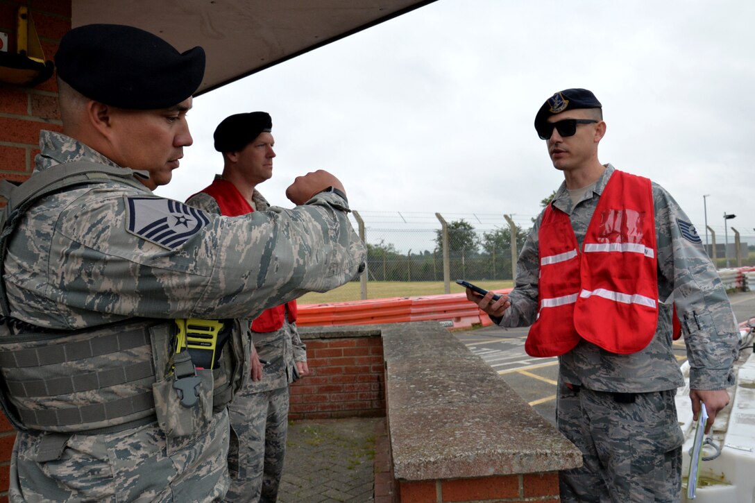 U.S. Air Force Master Sgt. Brad Miller, 100th Security Forces Squadron flight chief, speaks with Master Sgt. Matthew Kline and Tech. Sgt. Anthony Laspino, 100th Security Forces Squadron inspection team members, during an exercise at RAF Mildenhall, England, June 20, 2018. Such exercises are regularly scheduled to test responsiveness and readiness of base personnel. (U.S. Air Force photo by Tech. Sgt. David Dobrydney)