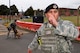 U.S. Air Force Master Sgt. Brad Miller, 100th Security Forces Squadron flight chief, speaks into his radio while Staff Sgt. Kristina Santos and Military Working Dog Ukkie stand ready in response to a simulated protest incident during an exercise at RAF Mildenhall, England, June 20, 2018. Such exercises are regularly scheduled to test responsiveness and readiness of base personnel. (U.S. Air Force photo by Tech. Sgt. David Dobrydney)