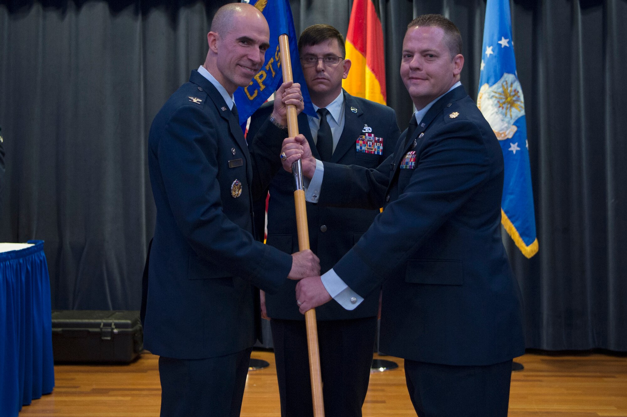 U.S. Air Force Col. Jason Bailey, 52nd Fighter Wing commander, left, gives the ceremonial guidon to U.S. Air Force Maj. Shawn Schulz, incoming 52nd Comptroller Squadron commander, during the 52nd CPTS change of command ceremony on Spangdahlem Air Base, Germany, June 18, 2018. (U.S. Air Force photo by Airman 1st Class Jovante Johnson)