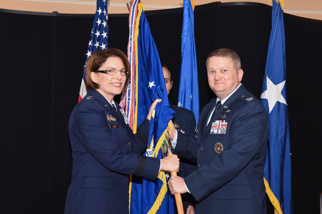 U.S. Air Force Maj. Gen. Mary O’Brian, 25th Air Force commander, hands the 480th Intelligence, Surveillance and Reconnaissance Wing guidion to the wing’s new commander, Col. Max Pearson, during a change of command ceremony June 19, 2018, at Joint Base Langley-Eustis, Virginia. As commander of the 480th ISRW, Pearson will direct the global operations of six ISR groups, providing world-class ISR to combatant commanders, Combined Forces Air Component commanders, Numbered Air Force commanders and coalition forces. (U.S. Air Force photo by Tech. Sgt. Darnell T. Cannady)