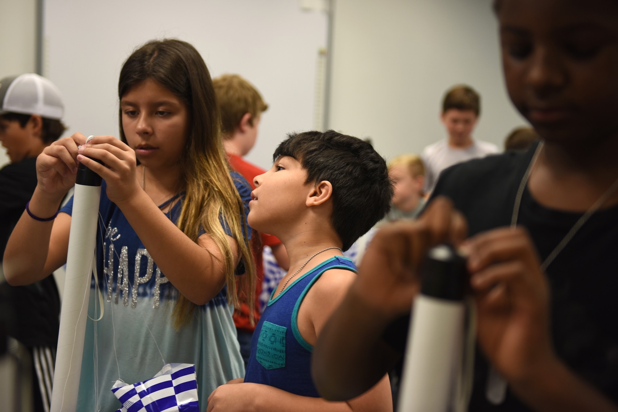 Valentina Olaya (left), helps Josue Samudil (right), son of U.S. Air Force Staff Sgt. Brittany Coleman, military pay technician with the 145th Comptroller Flight, with building his model rocket during a lesson held at the North Carolina Air National Guard Base, Charlotte-Douglas International Airport, June 18, 2018. The children are part of the annual Department of Defense STARBASE summer camp program and learn various applications of science, technology, engineering, and math.