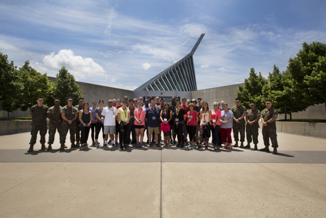 Quantico, Va - Marines and educators gather for a group photo outside the National Museum of the Marine Corps during Marine Corps Recruiting Command’s 2018 Educators’ and Key Leaders’ workshop , June 21. The workshop establishes mutually beneficial relationships between Marine officer selection officers and educators. Community leaders and educators from around the country travel to Quantico in efforts to develop better leadership skills and better opportunities in the Marine Corps. (U.S. Marine Corps photo by Pfc. Phuchung Nguyen)