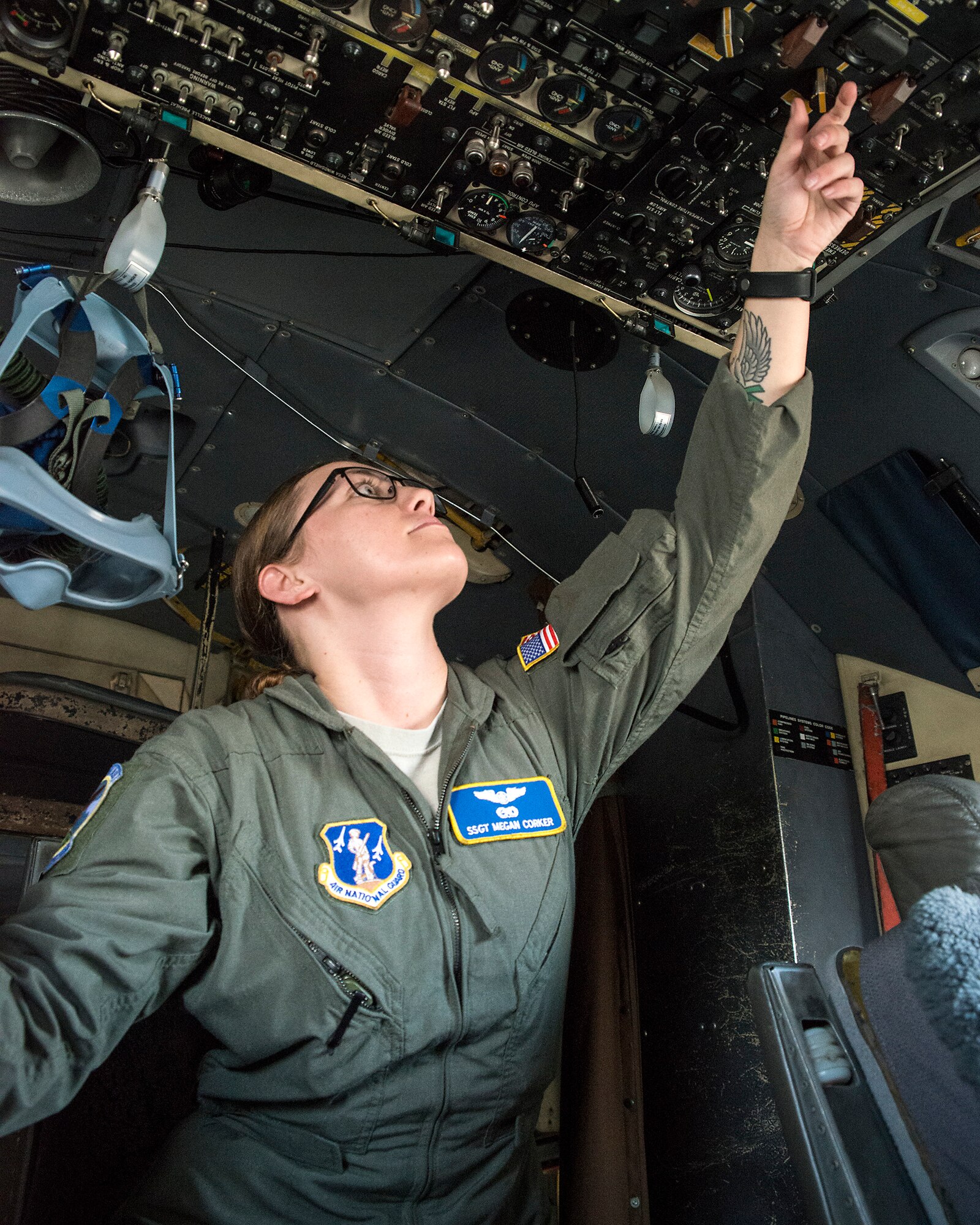 Flight engineer student performing checks on C-130H during final check ride.