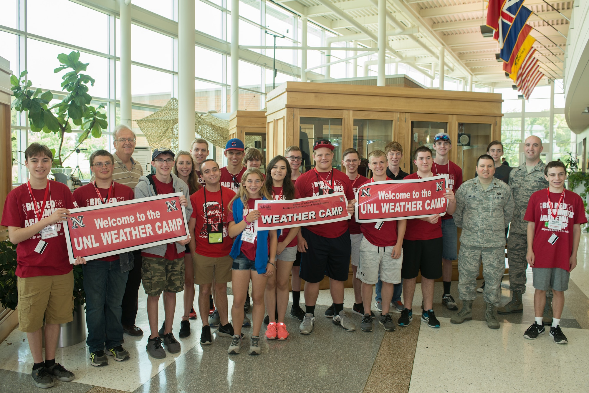 Students from the University of Nebraska-Lincoln Weather Camp pose for a group photo with 557th Weather Wing staff in the wing’s atrium June 12, 2018, Offutt Air Force Base, Nebraska. The students visited the wing as part of a career camp for high school students interested in meteorology. (U.S. Air Force photo by Paul Shirk)