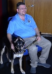 Ryan Kaono, a support agreement manager with the Air Force Installation and Mission Support Center, shares a laugh with a videographer during an interview while his service dog Romeo keeps a steady eye on the photographer. Romeo helps Kaono quickly recover from bouts of anxiety and night terrors related to enemy attacks while he was deployed to Saudi Arabia and Iraq.