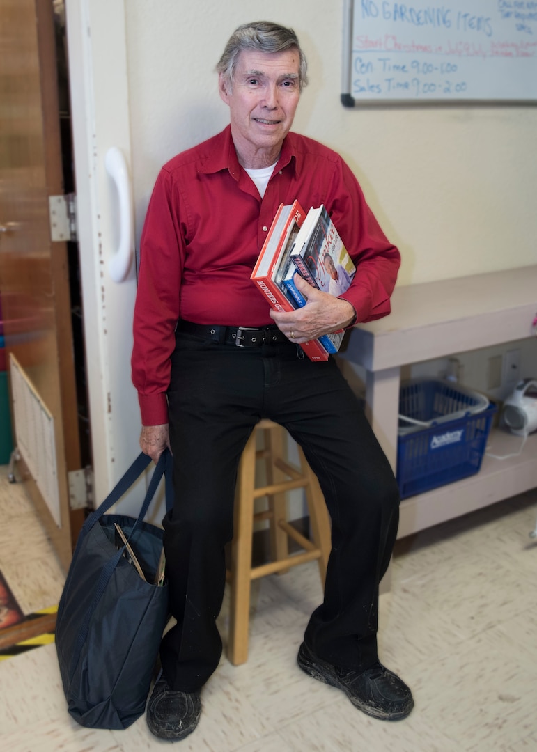 Ten-year customer Robert Wagner rests with his purchases after shopping at the Joint Base San Antonio-Randolph Thrift Shop June 18, 2018. Wagner enjoys shopping at the thrift shop along with its friendly atmosphere it provides. (U.S. Air Force photo by: Airman Shelby Pruitt)