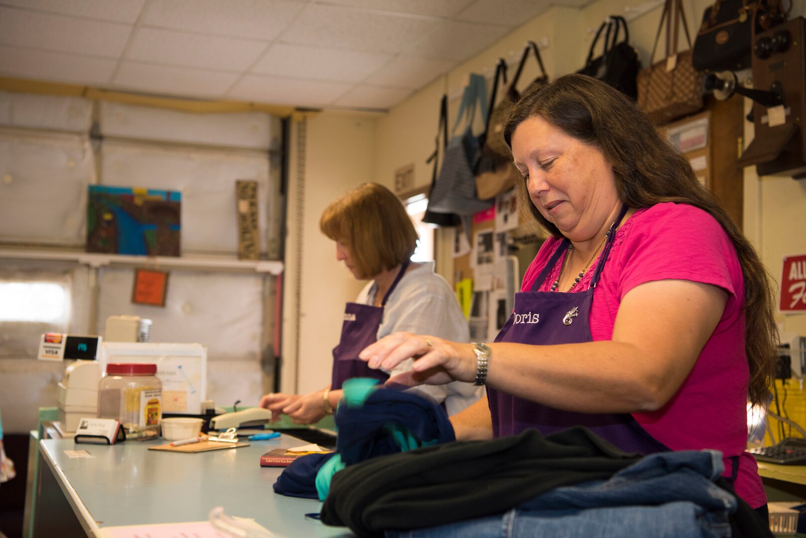 Volunteers at the Joint Base San Antonio-Randolph Thrift Shop check out customers June 18, 2018, on JBSA-Randolph, Texas. The shop has over 63 people helping it run smoothly, and most of these workers are volunteers.  (U.S. Air Force photo by: Airman Shelby Pruitt)