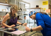 Longtime customer Sybil Tate shops through the jewelry counter June 18, 2018, at the thrift shop on JBSA-Randolph, Texas. The thrift shop on base offers items such as collectibles, books, clothing, decorations and furniture. (U.S. Air Force photo by: Airman Shelby Pruitt)