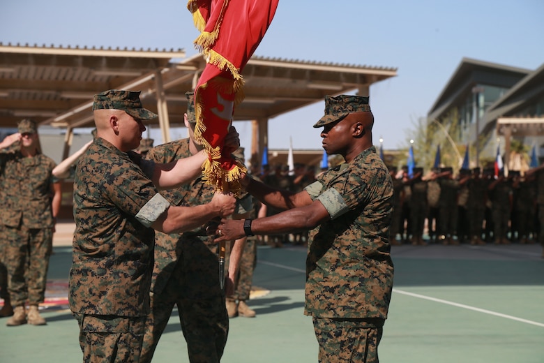 Lt. Col. Barian Woodward, off-going commanding officer, Communication Training Battalion, Marine Corps Communication-Electronics School, passes the battalion colors to Lt. Col. Russell Savatt, on-coming commanding officer, CTB, MCCES, at a change-of-command ceremony aboard the Marine Corps Air Ground Combat Center, Twentynine Palms, Calif., June 13, 2018. (U.S. Marine Corps photo by Lance Cpl. Preston L. Morris)