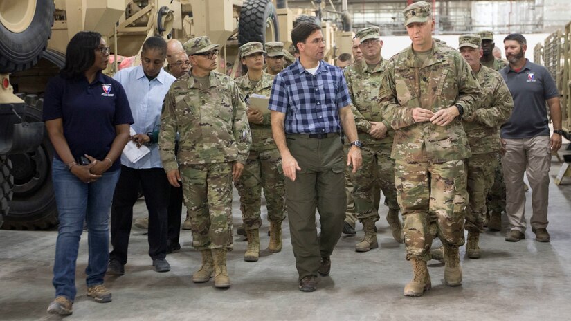 Secretary of the Army, Dr. Mark T. Esper takes a guided tour of a U.S. Army Prepositioned Stock warehouse led by Soldiers and Department of the Army Civilians at Camp Arifjan, Kuwait, June 21, 2018. APS warehouses are a strategic asset, which keep equipment readily available so deploying units can quickly respond to any contingency.