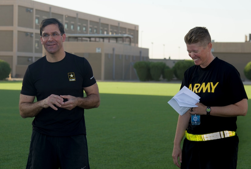 Secretary of the Army, Dr. Mark T. Esper and U.S. Army Cpt. Jill King, chief of the 49th Theater Gateway Company, laugh at a joke during physical readiness training with Soldiers from the 49th Theater Gateway Company at Camp Arifjan, Kuwait, June 21, 2018. This is the secretary’s first time visiting Camp Arifjan, Kuwait since he assumed his new position in November 2017.