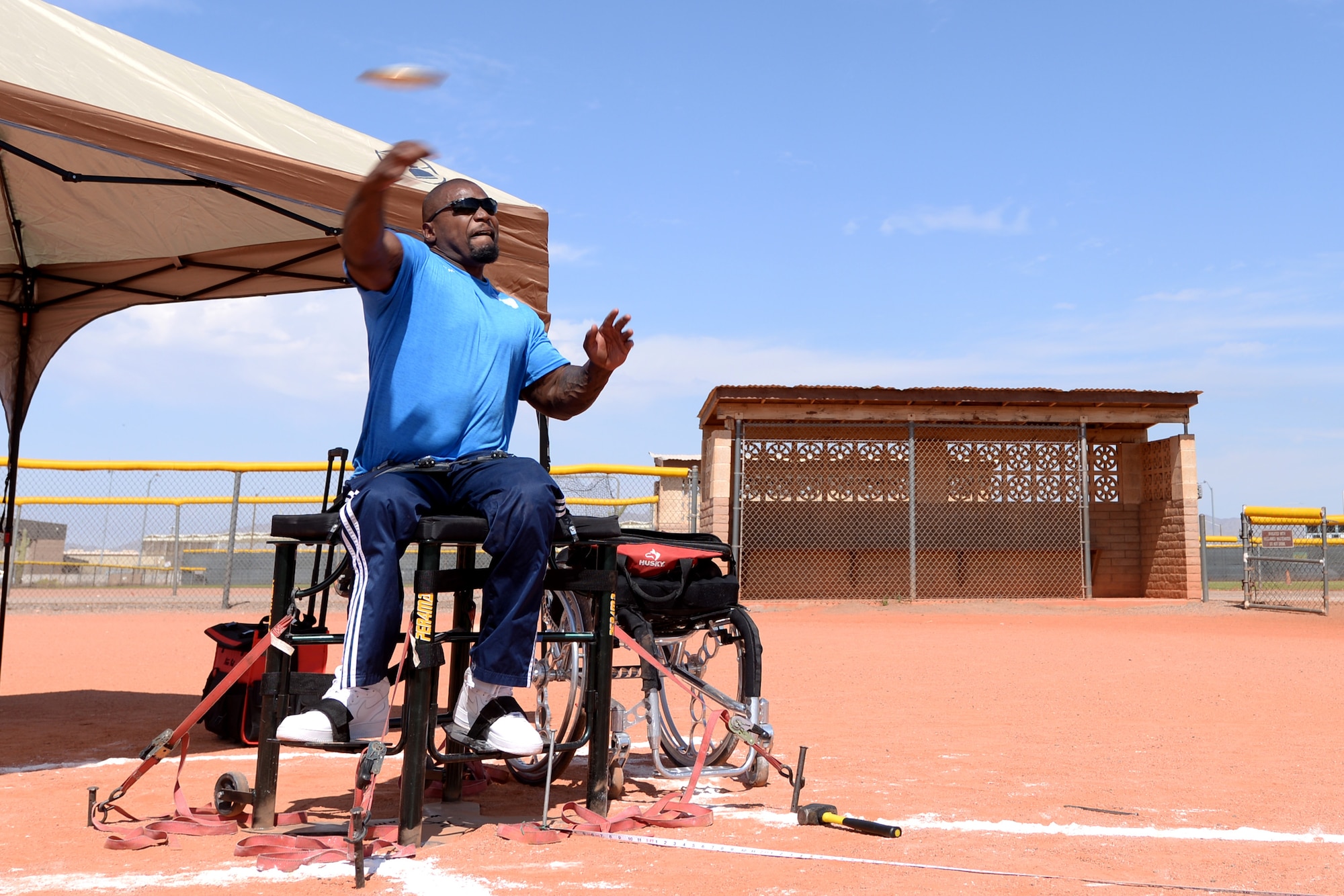 An adaptive athlete and Paralympic prospect throws a discus during training at Luke Air Force Base, Ariz., June 13, 2018. Several athletes stayed at Luke to train for the Desert Challenge adaptive sports competition at Arizona State University June 15-16. (U.S. Air Force photo by Senior Airman Ridge Shan)