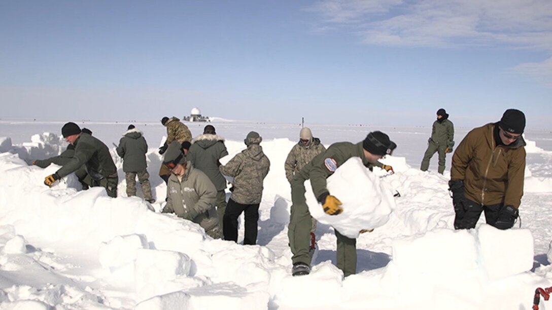Students build a shelter during cold weather survival training, commonly known as “Kool School,”at Raven Camp, Greenland.