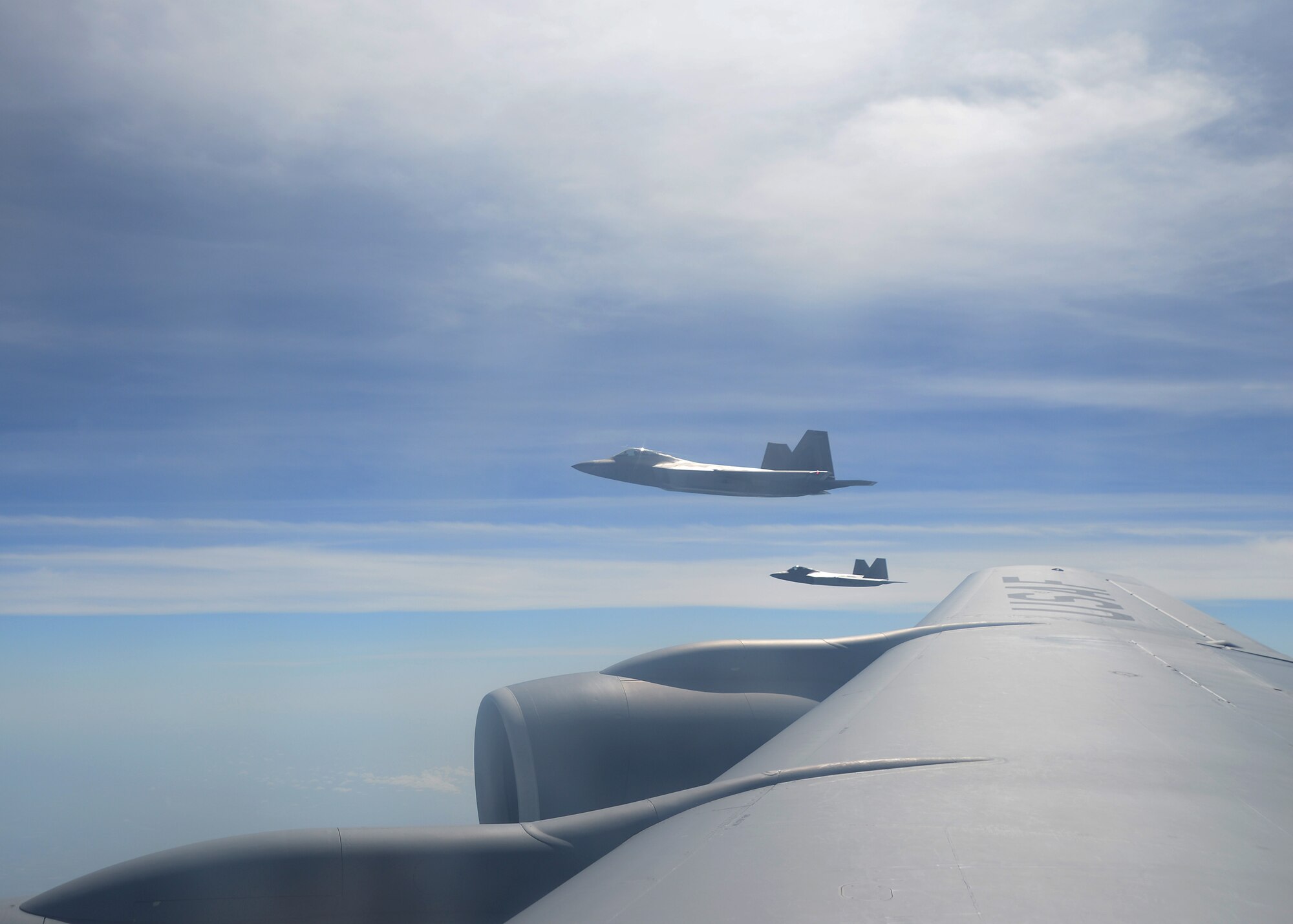 Two F-22A Raptors assigned to Tyndall Air Force Base, Fla., fly alongside a KC-135 Stratotanker aircraft assigned to MacDill Air Force Base, Fla, June 18, 2018.