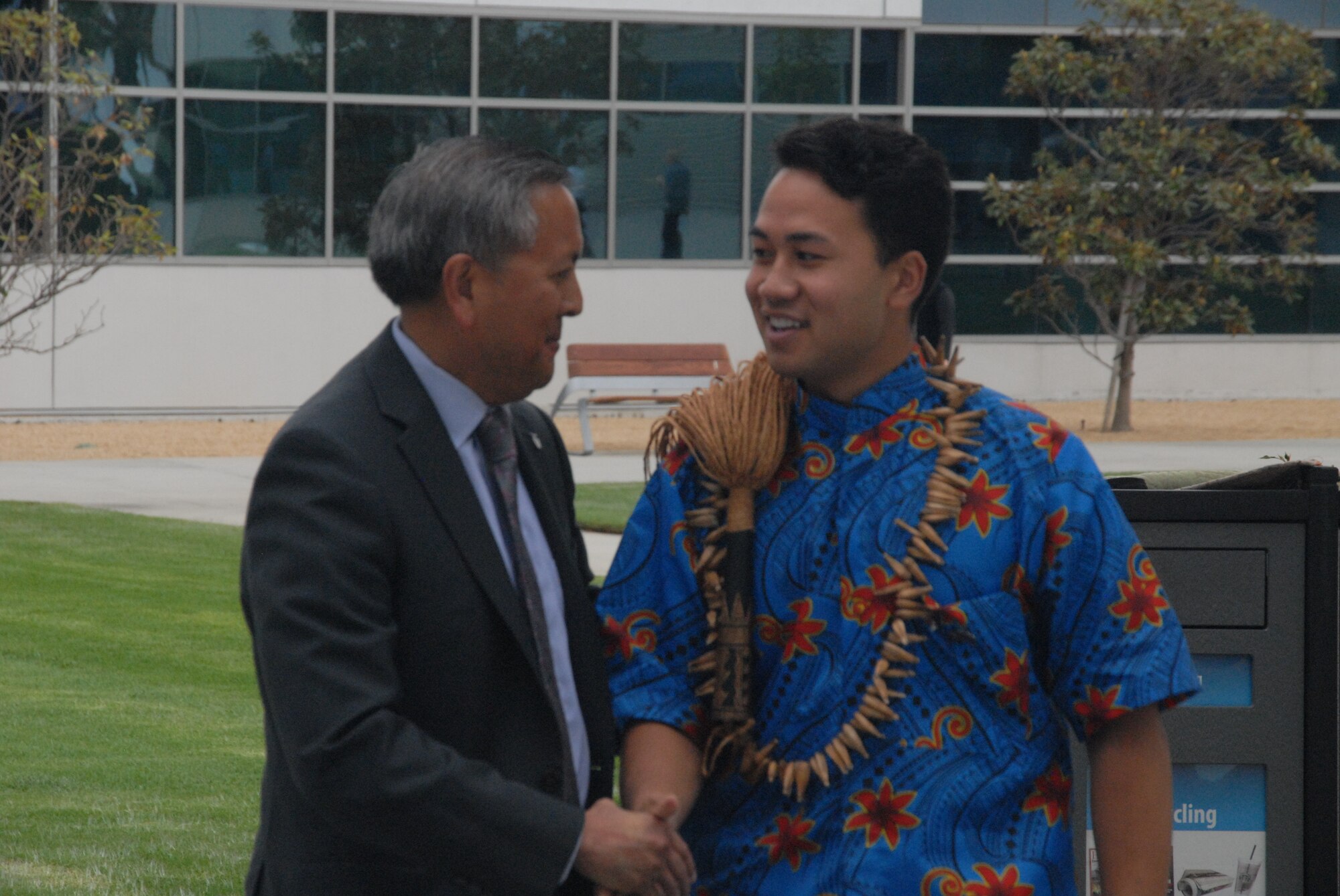 Mr. Cordell A. DeLaPena, director of SMC’s Program Management and Integration Directorate, congratulates Charles Ulualofaiga Coleman II, the first Associated Student of Loyola Marymount University president and a native Hawaiian with Samoan heritage for singing “"Lo Ta Nu”u"” - (My Dear Island Nation) during the 25th anniversary of Asian American Pacific Islander Heritage Month at Los Angeles Air Force Base