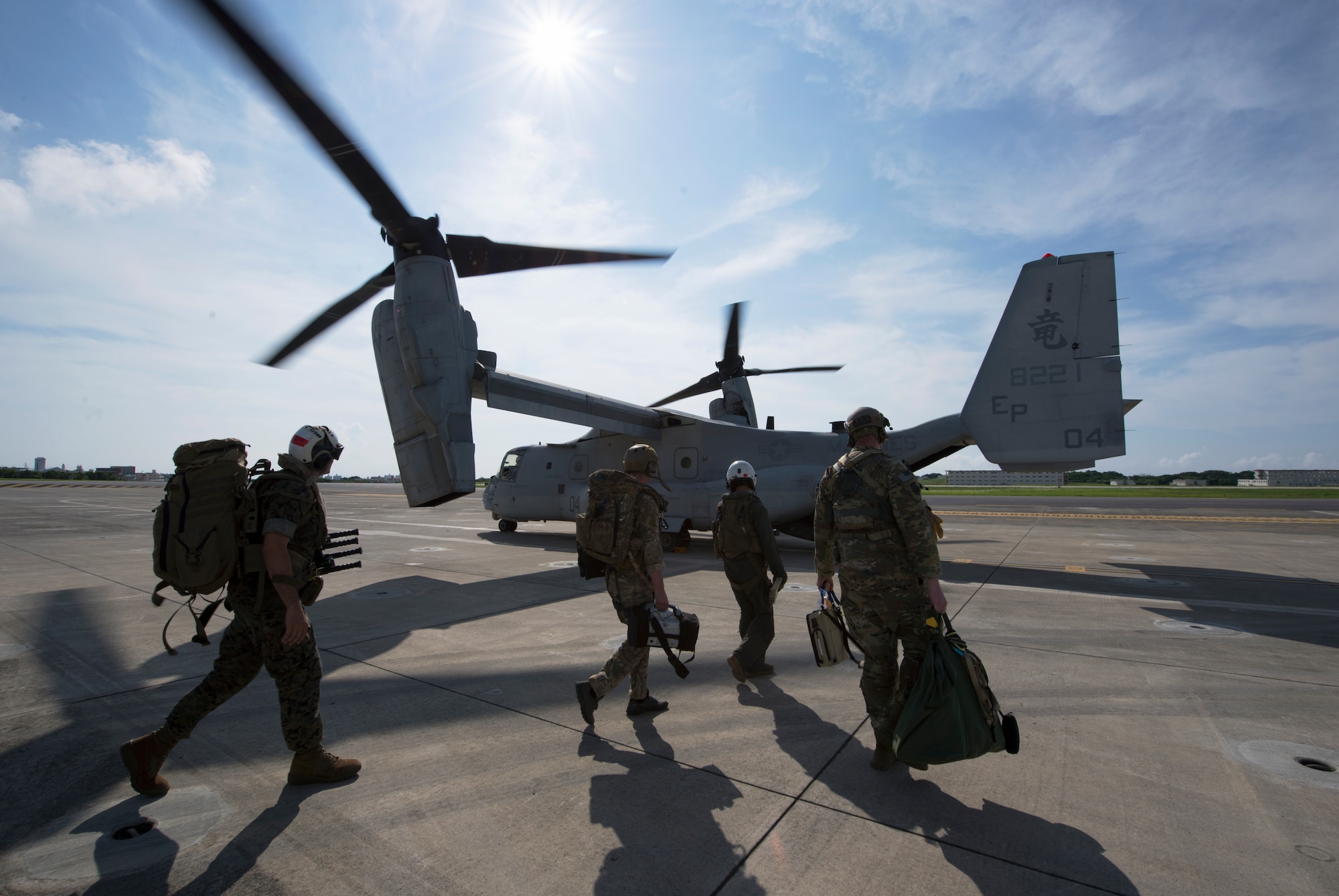 Members of the U.S. Air Force, Navy and Marines, board an MV-22 Osprey June 6, 2018, at Marine Corps Air Station, Okinawa, Japan during an exercise. The Air Force performs joint medical exercises with other U.S. forces regularly in Okinawa to better prepare service members for real world emergencies. (U.S. Air Force photo by Senior Airman Thomas Barley)