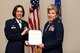 U.S. Air Force Col. Janet Urbanski, 17th Medical Group commander, presents a meritorious service certificate to Col. Kari Stone, 17th Medical Operation Squadron outgoing commander, during the 17th MDOS Change of Command at the Event Center on Goodfellow Air Force Base, Texas, June 21, 2018. Stone was the 17th MDOS commander for two years and directed ambulatory health services for 12,000 beneficiaries and 14,000 students.  (U.S. Air Force photo by Airman 1st Class Seraiah Hines/Released)