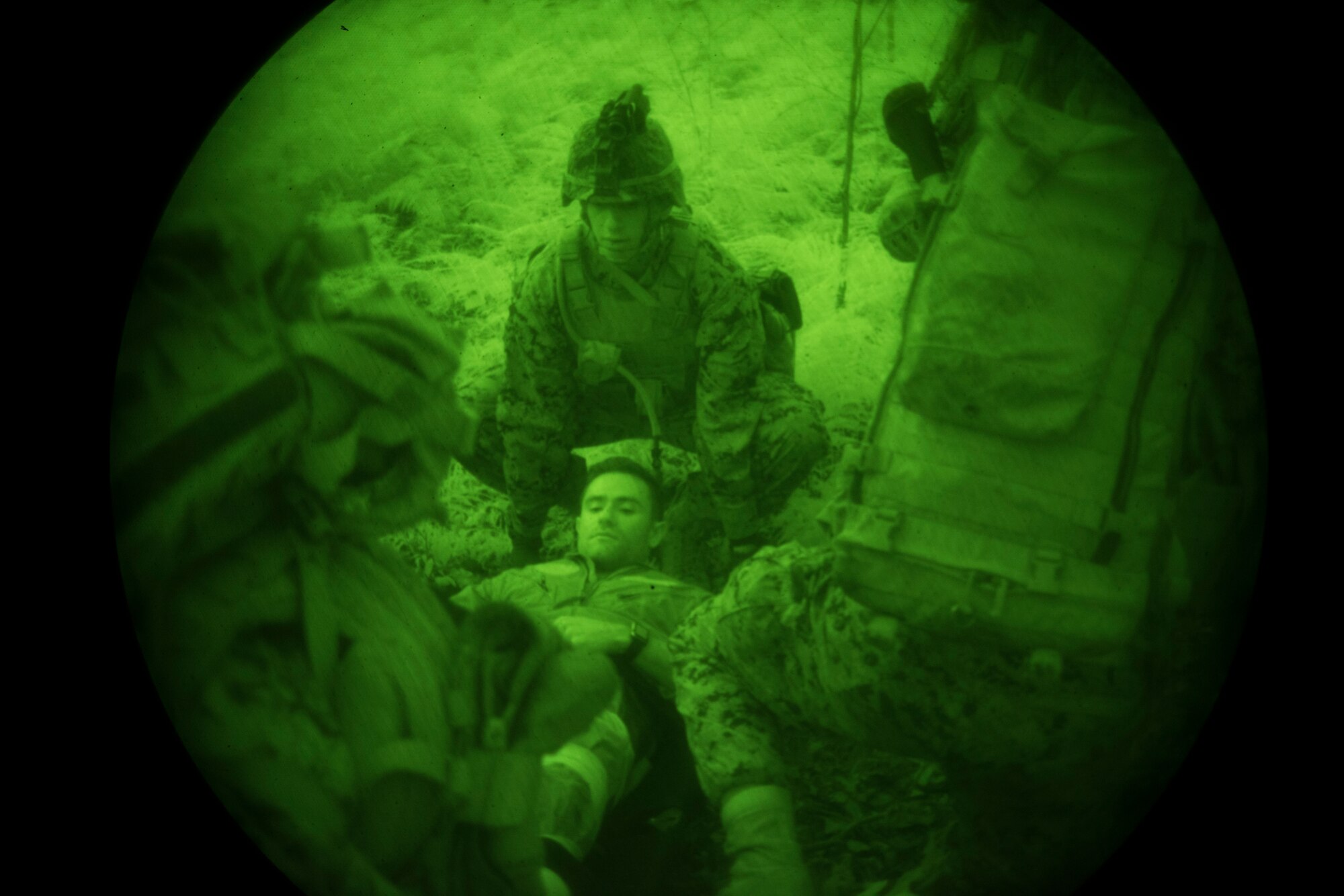 Company F, 2nd Battalion, 25th Marine Regiment Marines carry a pilot on a stretcher during a rescue exercise on Fort Indiantown Gap, P.A., June 14, 2018. The Marines were tasked to extract two wounded pilots from an aircraft crash while avoiding enemy fire. The exercise was a part of a two-week operation called the 2018 Marine Aircraft Group-49 Combined Arms Exercise that encouraged joint combat training. (U.S. Air Force photo by Airman Ariel Owings)