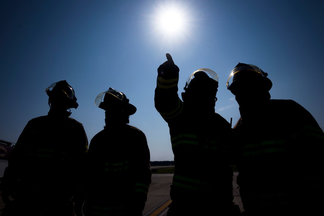 Firefighters from the 23d Civil Engineer Squadron (CES), discuss strategy prior to an HH-60G Pave Hawk rescue training scenario, June 19, 2018, at Moody Air Force Base, Ga. 23d CES firefighters conducted the training to evaluate their overall knowledge and preparation of how to properly shut down and rescue crew members from an HH-60. (U.S. Air Force photo by Airman 1st Class Eugene Oliver)