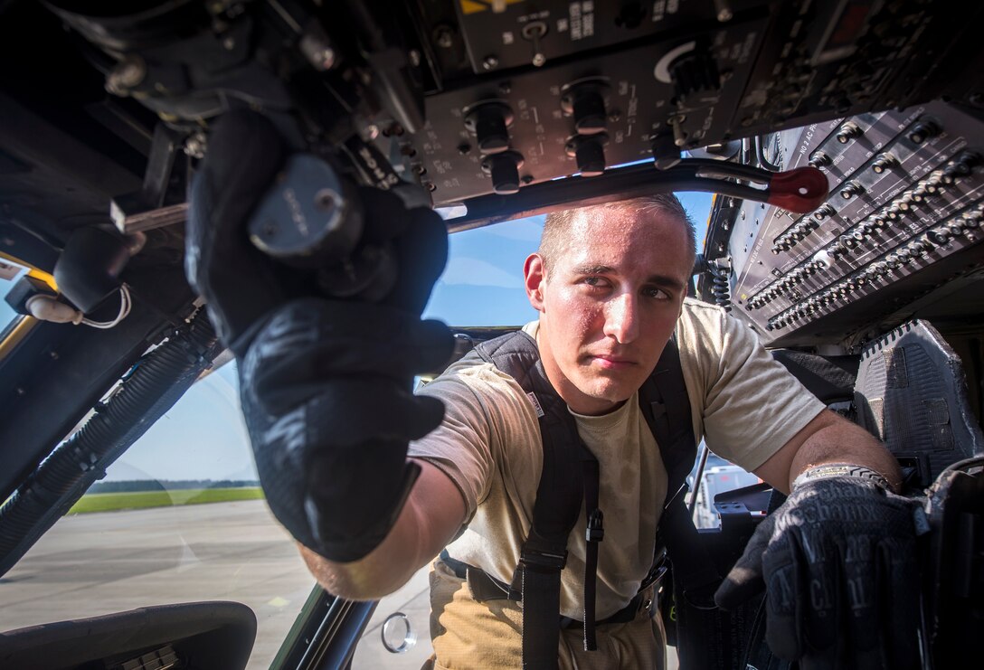 Staff Sgt. Matthew Montville, 23d Civil Engineer Squadron (CES) firefighter, pulls back the throttle of an HH-60G Pave Hawk at the conclusion of a simulated rescue training scenario, June 19, 2018, at Moody Air Force Base, Ga. 23d CES firefighters conducted the training to evaluate their overall knowledge and preparation of how to properly shut down and rescue crew members from an HH-60. (U.S. Air Force photo by Airman 1st Class Eugene Oliver)