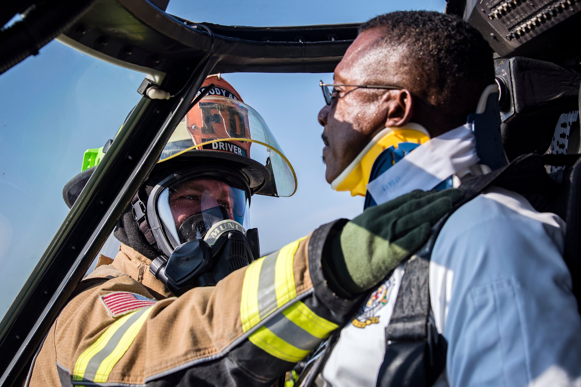 Senior Airman James Muncy, left, 23d Civil Engineer Squadron (CES) firefighter, applies a neck brace onto Charlie Johnson, 23d CES assistant fire chief, during an HH-60G Pave Hawk simulated rescue training scenario, June 20, 2018, at Moody Air Force Base, Ga. 23d CES firefighters conducted the training to evaluate their overall knowledge and preparation of how to properly shut down and rescue crew members from an HH-60. (U.S. Air Force photo by Airman 1st Class Eugene Oliver)