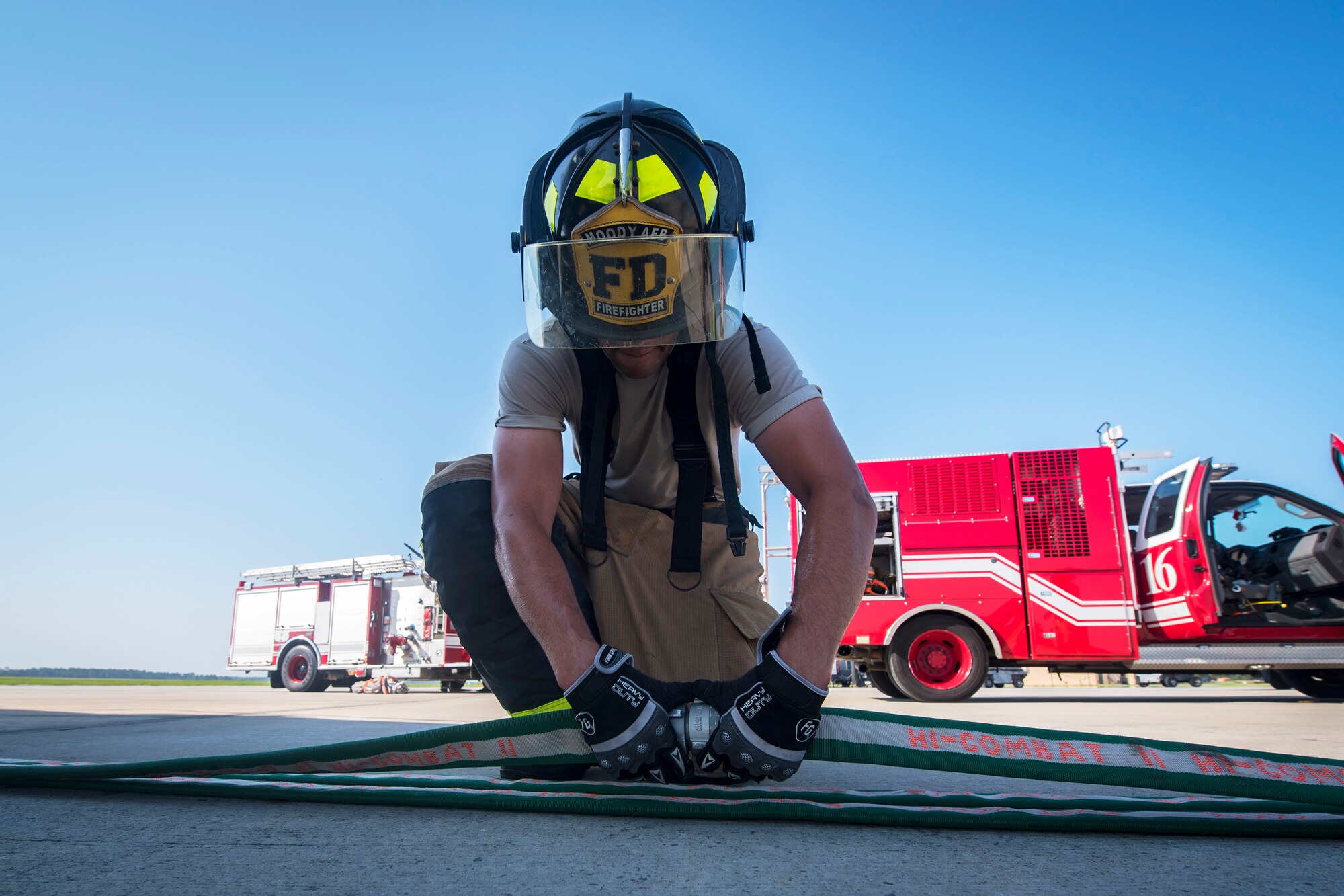 Senior Airman James Muncy, left, 23d Civil Engineer Squadron (CES) firefighter, detaches a hose following an HH-60G Pave Hawk simulated rescue training scenario, June 20, 2018, at Moody Air Force Base, Ga. 23d CES firefighters conducted the training to evaluate their overall knowledge and preparation of how to properly shut down and rescue crew members from an HH-60. (U.S. Air Force photo by Airman 1st Class Eugene Oliver)