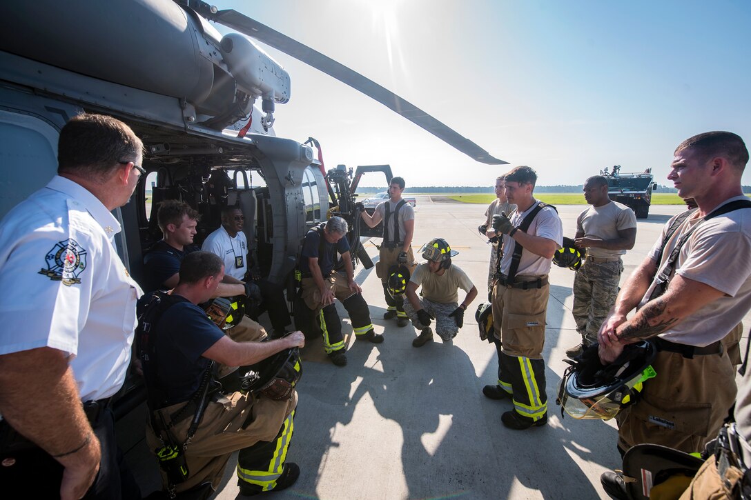 Firefighters from the 23d Civil Engineer Squadron (CES), discuss their performance following an HH-60G Pave Hawk simulated rescue training scenario, June 20, 2018, at Moody Air Force Base, Ga. 23d CES firefighters conducted the training to evaluate their overall knowledge and preparation of how to properly shut down and rescue crew members from an HH-60. (U.S. Air Force photo by Airman 1st Class Eugene Oliver)
