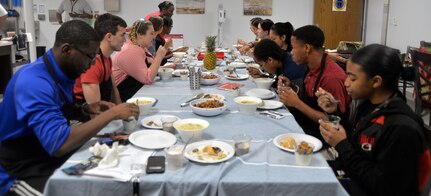 Students enjoy a lunch of chicken, wraps, ramen noodles and yogurt they prepared during the Resiliency Day workshop June 15 at the Vogel Resiliency Center at Joint Base San Antonio-Fort Sam Houston. The workshop allowed students of JBSA members from area high schools to learn about life skills, including how to prepare and cook nutritious, delicious meals.
