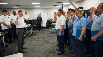 Robert West, 12th Maintenance Group director, administers an oath of service to members of the 12th MXG who have completed a civilian professional development course June 22, 2018, at Joint Base San Antonio-Randolph, Texas. An estimated 140 employees have completed the program to date, and the 12th MXG offers the workshop to 12 employees once a quarter.