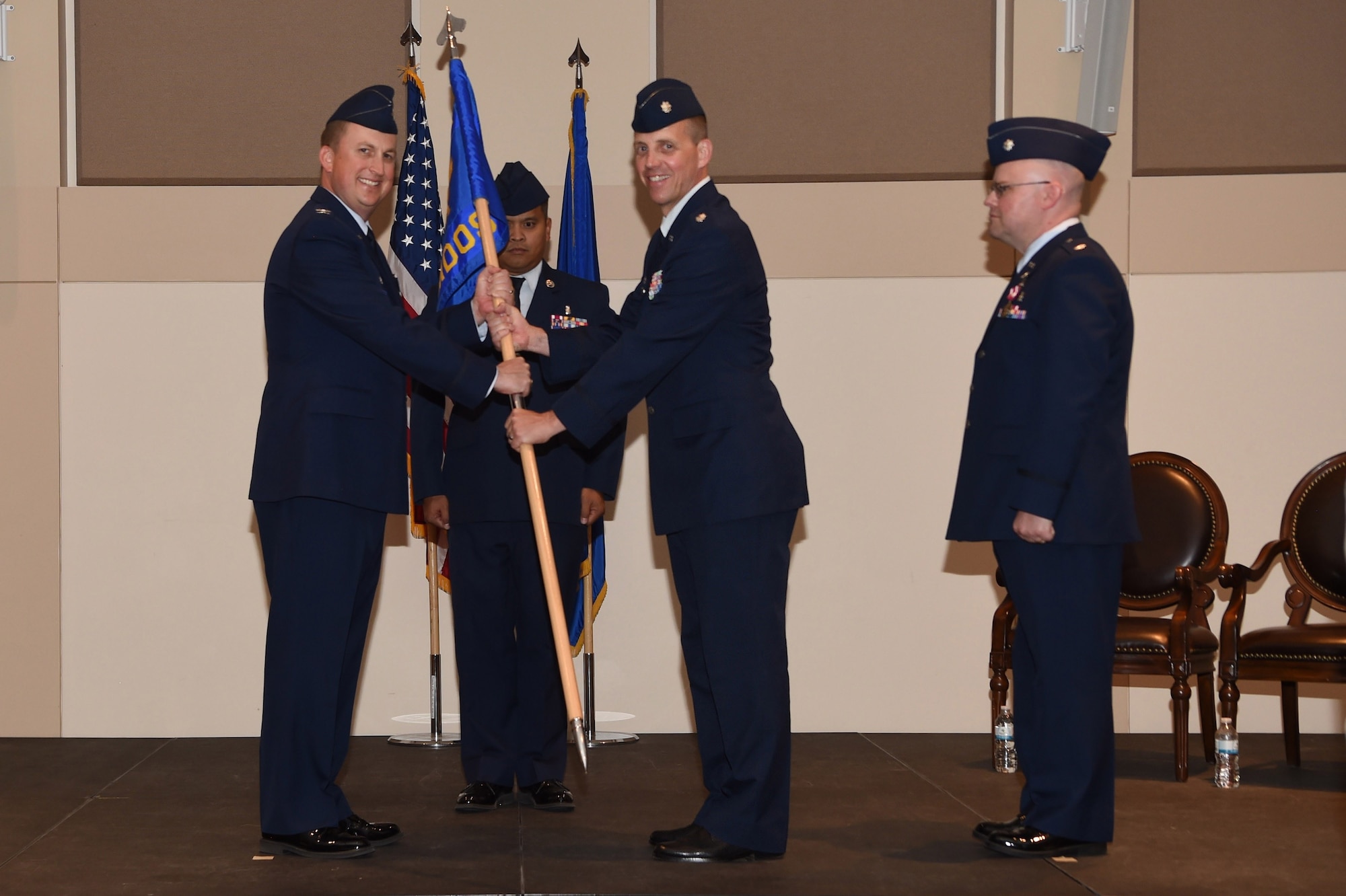 Lt Col. Christian Smith, 460th Space Warning Squadron incoming commander, receives the guidon, symbolizing the change of command from one individual to another June 15, 2018, on Buckley Air Force Base, Colorado. The 460th MDOS mission is to provide medical and preventive health care to all wing and associated non-flying personnel and their dependents. (U.S. Air Force photo by Airman 1st Class Codie Collins)