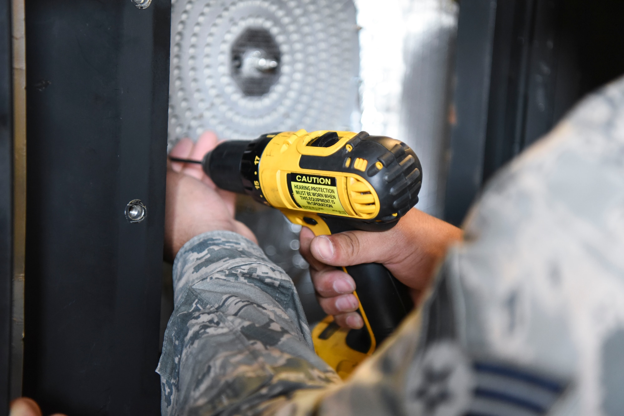 Senior Airman Kristian Martinez-felix, a 319th Civil Engineer Squadron heating, ventilation, air conditioning and refrigeration apprentice unscrews a water boiler June 20, 2018, on Grand Forks Air Force Base, North Dakota. Martinez-Felix unscrews the water boiler so that he can see if it has possible overflow or needs cleaning. (U.S. Air Force photo by Airman 1st Class Melody Wolff)