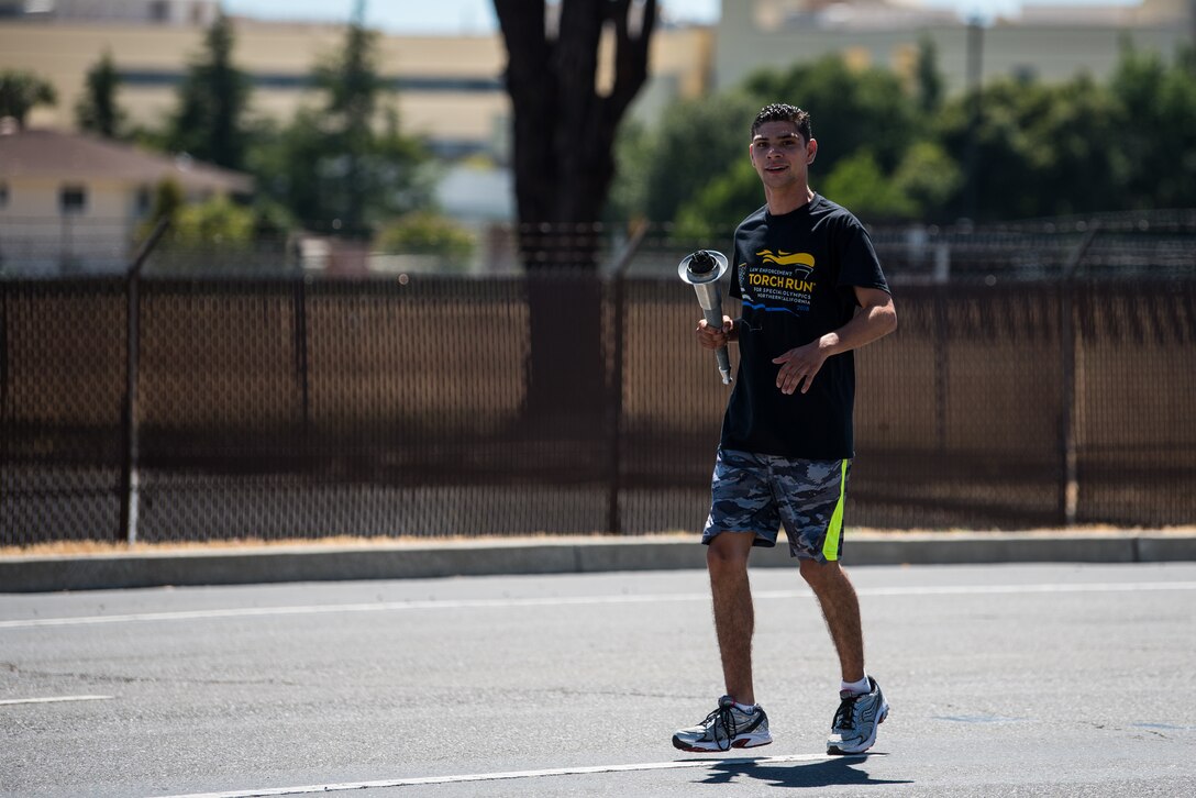 Special Olympian Eric Silva, participates in the 2018 Special Olympics Torch Run at Travis Air Force Base, Calif., June 20, 2018. The annual event brings law enforcement from the community and the base together to show their support for Special Olympics and the athletes who participate in the games. (U.S. Air Force Photo by Master Sgt. Joey Swafford)