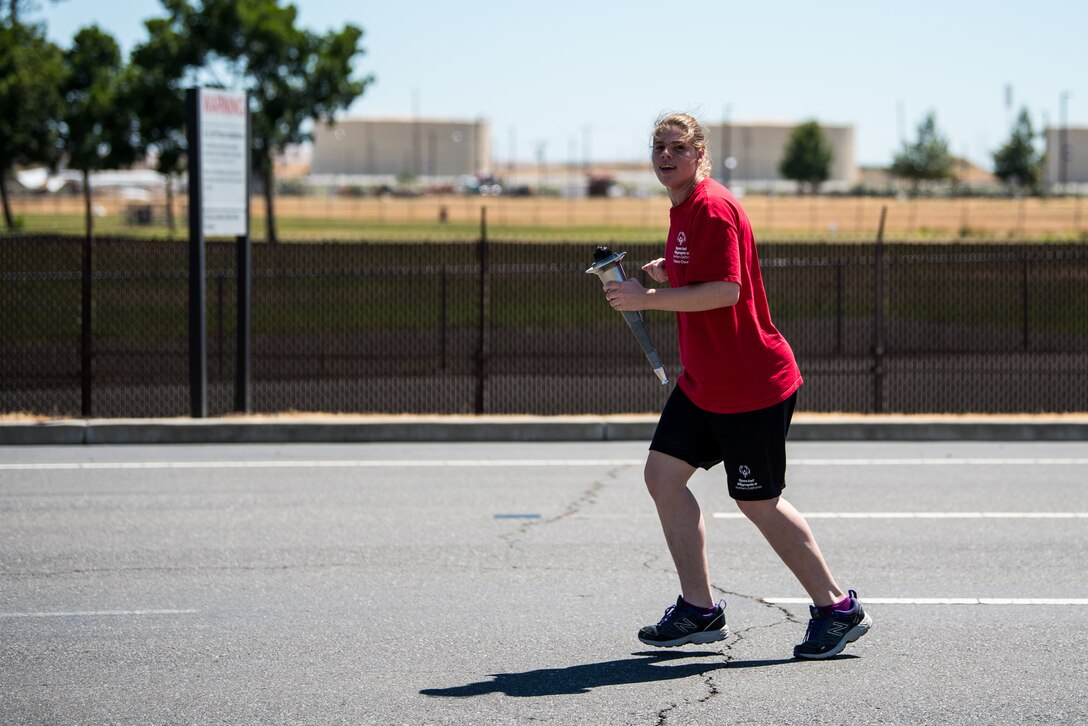 Special Olympian Alexis Norman, participates in the 2018 Special Olympics Torch Run at Travis Air Force Base, Calif., June 20, 2018. The annual event brings law enforcement from the community and the base together to show their support for Special Olympics and the athletes who participate in the games. (U.S. Air Force Photo by Master Sgt. Joey Swafford)
