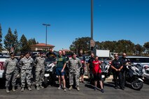 Special Olympians, Airmen with the 60th Security Forces Squadron and members of the Fairfield Police Department pose for a photo during the 2018 Special Olympics Torch Run at Travis Air Force Base, Calif., June 20, 2018. The annual event brings law enforcement from the community and the base together to show their support for Special Olympics and the athletes who participate in the games. (U.S. Air Force Photo by Master Sgt. Joey Swafford