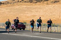 Special Olympians and Airmen with the 60th Security Forces Squadron finish a stage of the 2018 Special Olympics Torch Run in Vacaville, Calif., June 21, 2018. The annual event brings law enforcement from the community and the base together to show their support for Special Olympics and the athletes who participate in the games. (U.S. Air Force Photo by Master Sgt. Joey Swafford)
