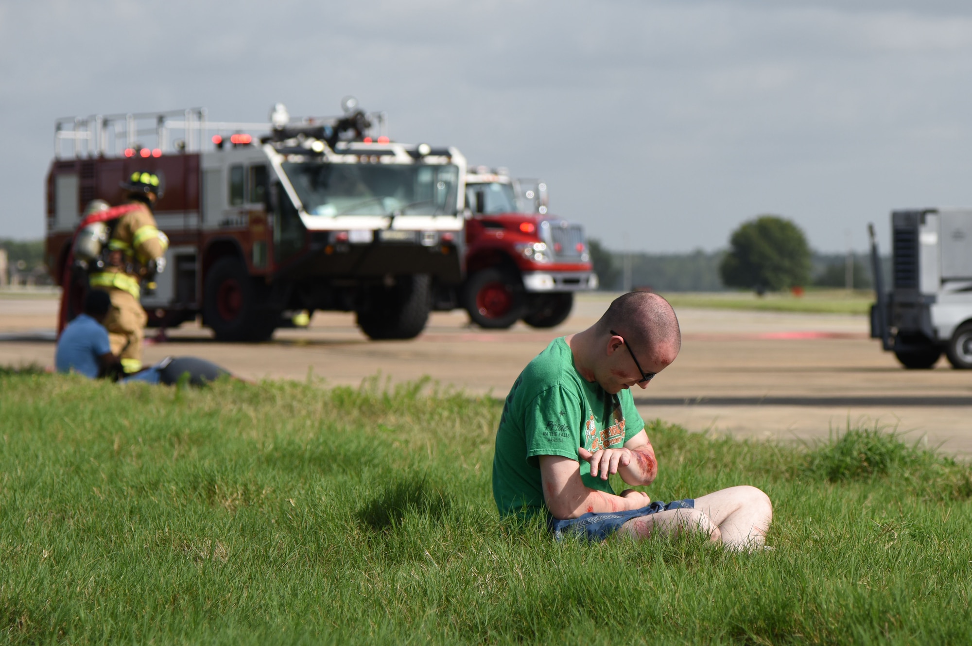 U.S. Air Force Staff Sgt. Robert Herr, 333rd Training Squadron student, portrays a “victim” during a major accident response exercise on the flight line at Keesler Air Force Base, Mississippi, June 21, 2018. The exercise scenario simulated a C-130J Super Hercules in-flight emergency causing a plane crash, which resulted in a mass casualty response event. This exercise tested the base’s ability to respond in a crisis situation. (U.S. Air Force photo by Kemberly Groue)