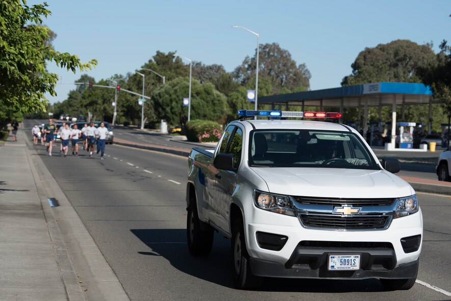 A security forces patrol vehicle leads the way for the annual Law Enforcement Torch Run June 21, 2018, at Travis Air Force Base, Calif. During the run, Special Olympics athletes ran alongside Airmen from the 60th Security Forces Squadron with one of the athletes carrying the torch known as the “Flame of Hope.” The Northern California Special Olympics Summer Games will take place at the University of California Davis from June 22 - 24. (U.S. Air Force photo by Tech. Sgt. James Hodgman)