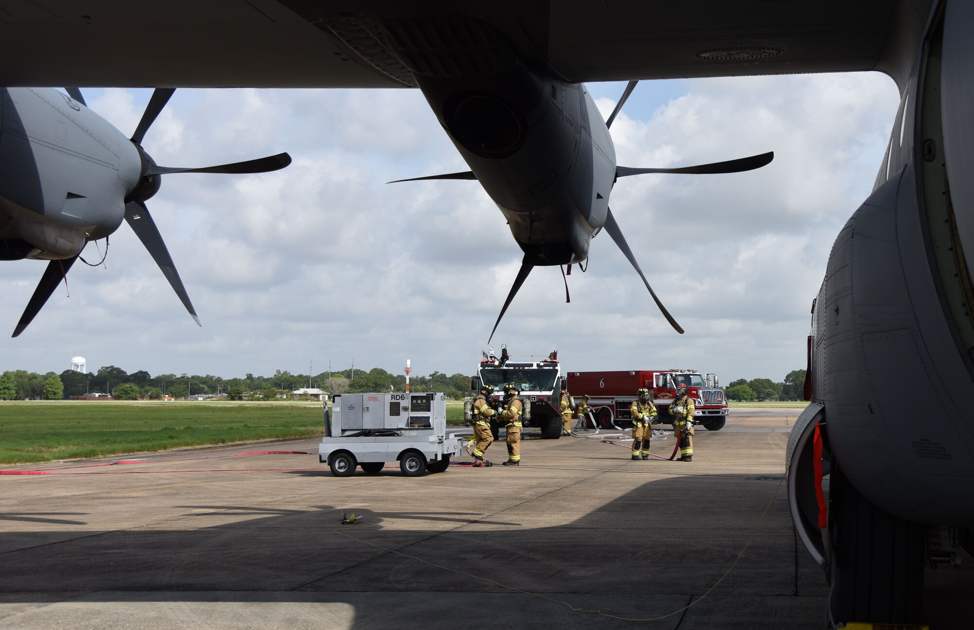 Keesler Firefighters arrive on scene during a major accident response exercise on the flight line at Keesler Air Force Base, Mississippi, June 21, 2018. The exercise scenario simulated a C-130J Super Hercules in-flight emergency causing a plane crash, which resulted in a mass casualty response event. This exercise tested the base’s ability to respond in a crisis situation. (U.S. Air Force photo by Kemberly Groue)