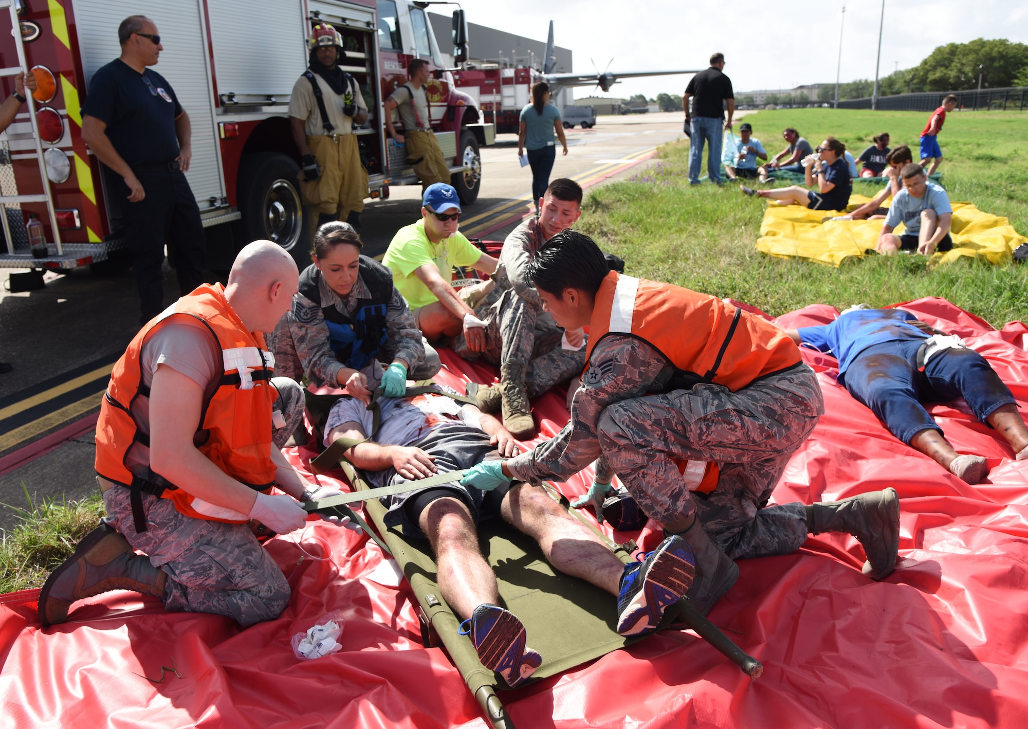 Members of the 81st Medical Group provide triage to “victims” during a major accident response exercise on the flight line at Keesler Air Force Base, Mississippi, June 21, 2018. The exercise scenario simulated a C-130J Super Hercules in-flight emergency causing a plane crash which resulted in a mass casualty response event. This exercise tested the base’s ability to respond in a crisis situation. (U.S. Air Force photo by Kemberly Groue)