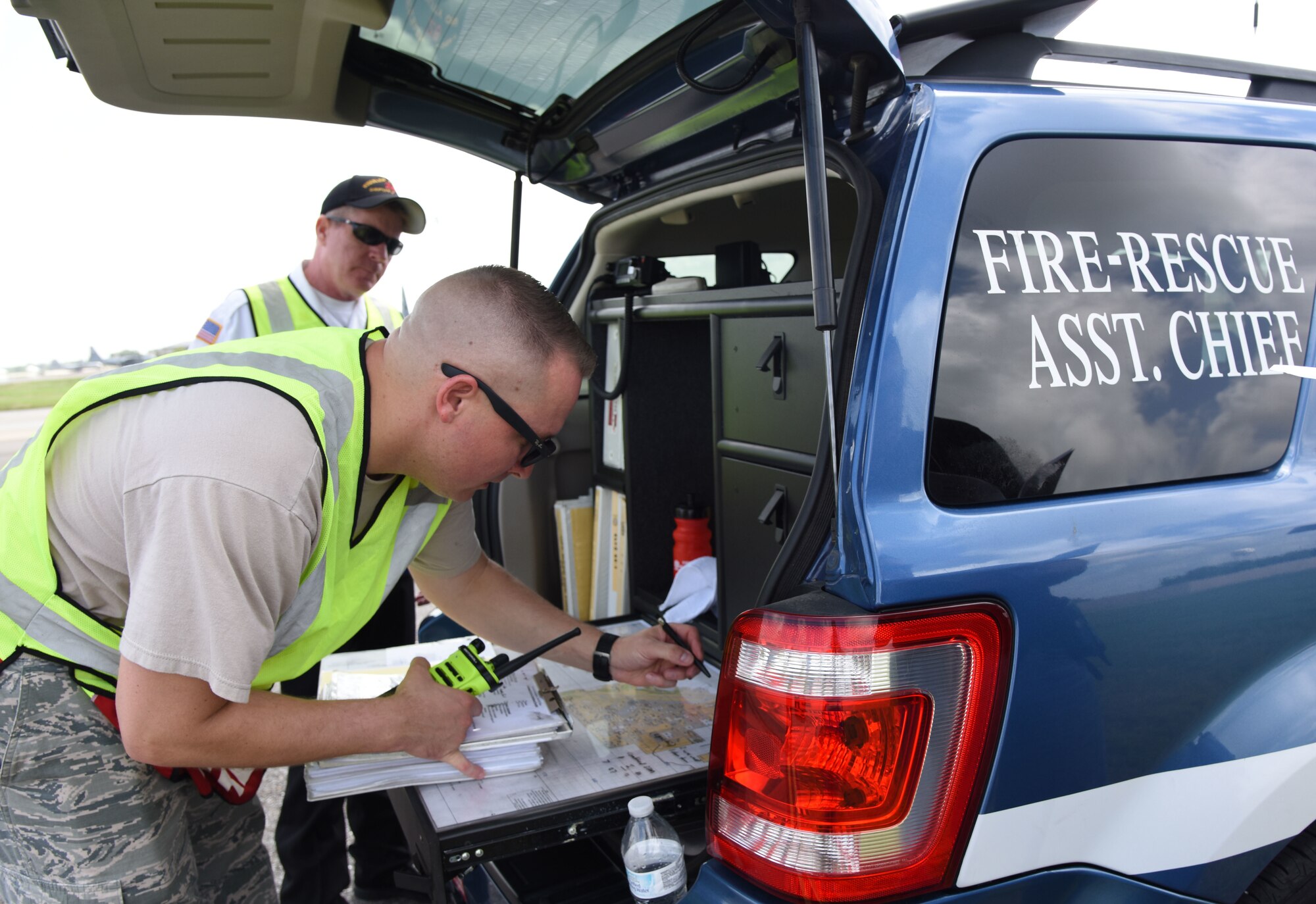 U.S. Air Force Master Sgt. Dan Blankenship, 81st Infrastructure Division operations assistant chief and Gary Pierson, 81st ID deputy fire chief, document the number of victims at the crash site during a major accident response exercise on the flight line at Keesler Air Force Base, Mississippi, June 21, 2018. The exercise scenario simulated a C-130J Super Hercules in-flight emergency causing a plane crash which resulted in a mass casualty response event. This exercise tested the base’s ability to respond in a crisis situation. (U.S. Air Force photo by Kemberly Groue)